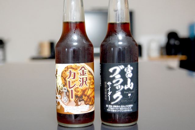 北陸地方のご当地グルメをイメージした「金沢カレーコーラ」と「富山ブラックサイダー」